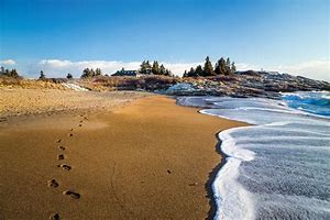 Photo from DownEast Magazine. Beach and rocky headland at Reid State Park, Maine. 20 miles from Wiscasset Woods Lodge